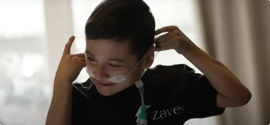 Image type: OTHERWISE Young boy adjusts medical equipment with a