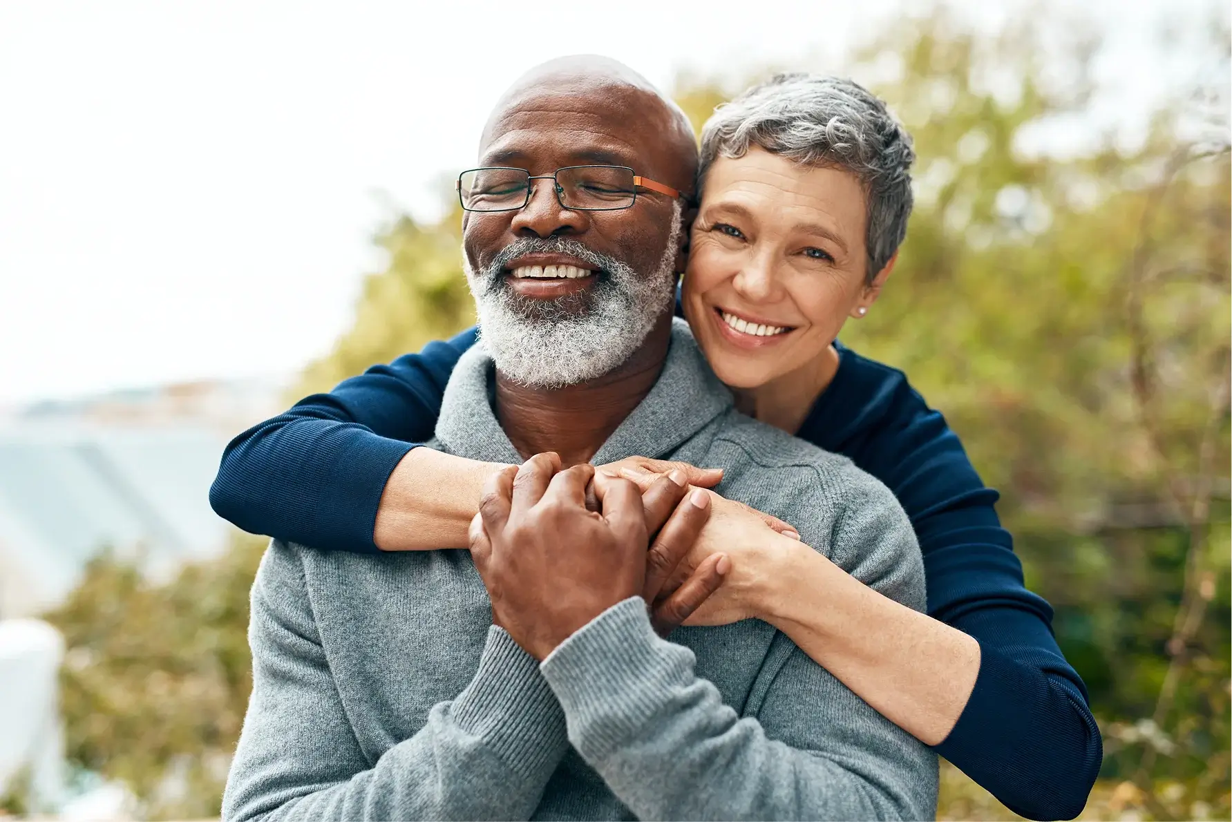 Happy senior couple embracing outdoors and enjoying time together